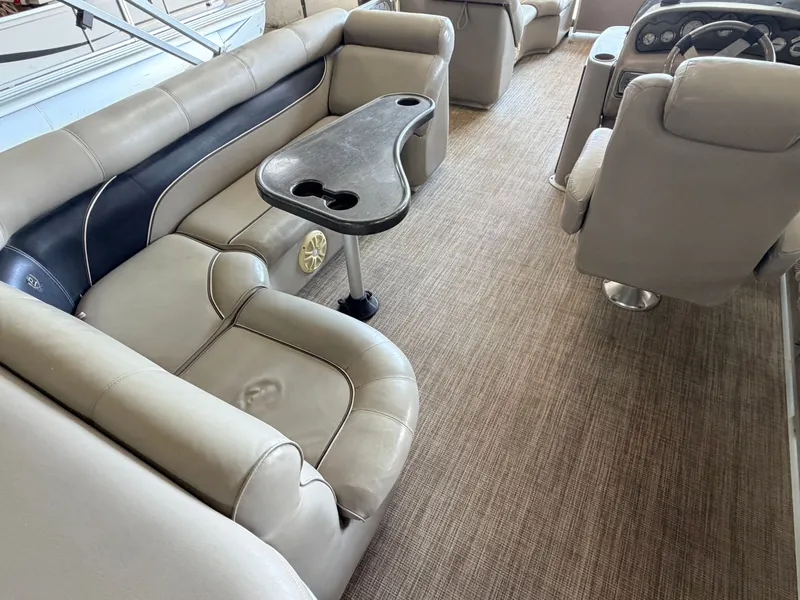Slide: The Image of Interior of a 2007 Premier 210 Legend with beige seating and a table. - 5