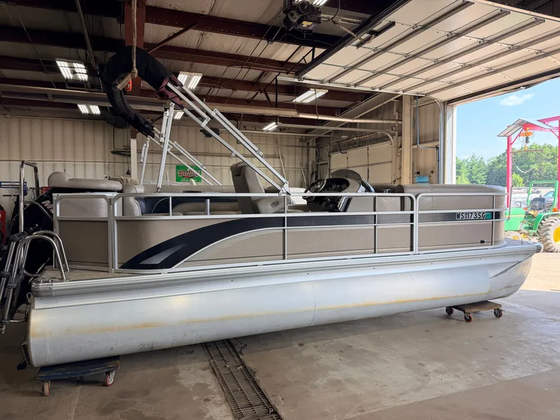 Slide: The Image of A 2007 Premier 210 Legend pontoon boat inside a garage. - 15