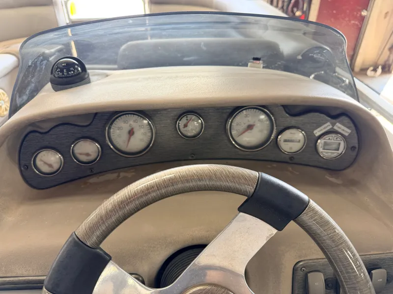 Slide: The Image of The image shows the dashboard of a 2007 Premier 210 Legend boat with several gauges. - 22