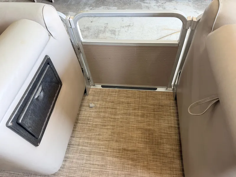 Slide: The Image of The image shows the interior of a 2007 Premier 210 Legend with beige seating and carpeted floor. - 13