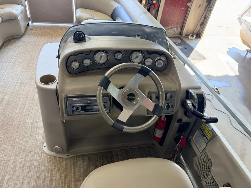 Slide: The Image of The image shows the helm of a 2007 Premier 210 Legend with steering wheel and gauges. - 21