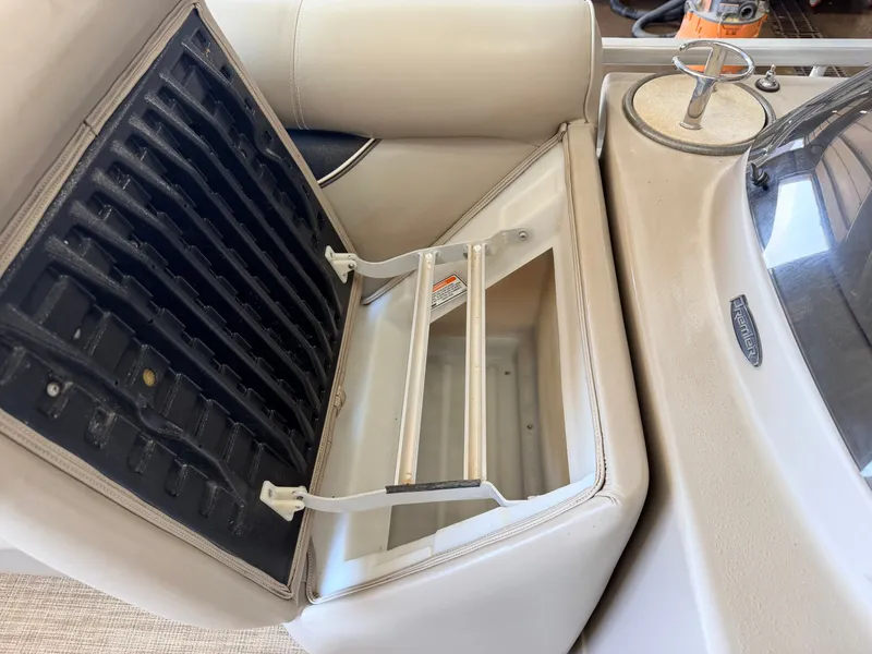 Slide: The Image of An open storage compartment with a removable insert on a boat. - 12
