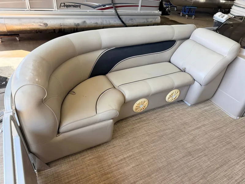 Slide: The Image of Interior of a 2007 Premier 210 Legend with beige upholstered seating and speakers. - 10