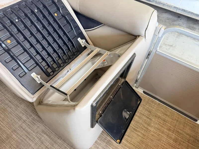 Slide: The Image of A seat with an open storage compartment and flap on a boat. - 29