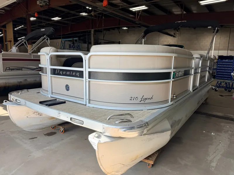Slide: The Image of A 2007 Premier 210 Legend pontoon boat in a storage facility. - 36