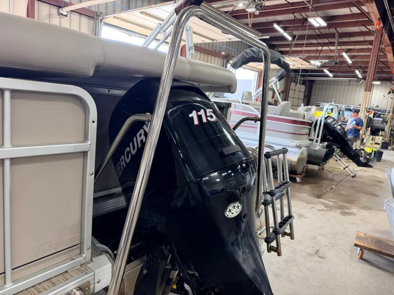 Slide: The Image of A 2007 Premier 210 Legend with a Mercury 115 outboard motor in a workshop. - 50