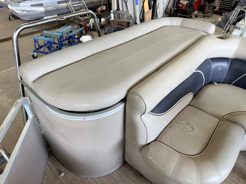 Slide: The Image of The image shows the seating area of a 2007 Premier 210 Legend with beige upholstery. - 8