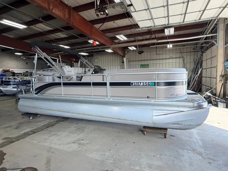 Slide: The Image of A 2007 Premier 210 Legend pontoon boat in a storage facility. - 45