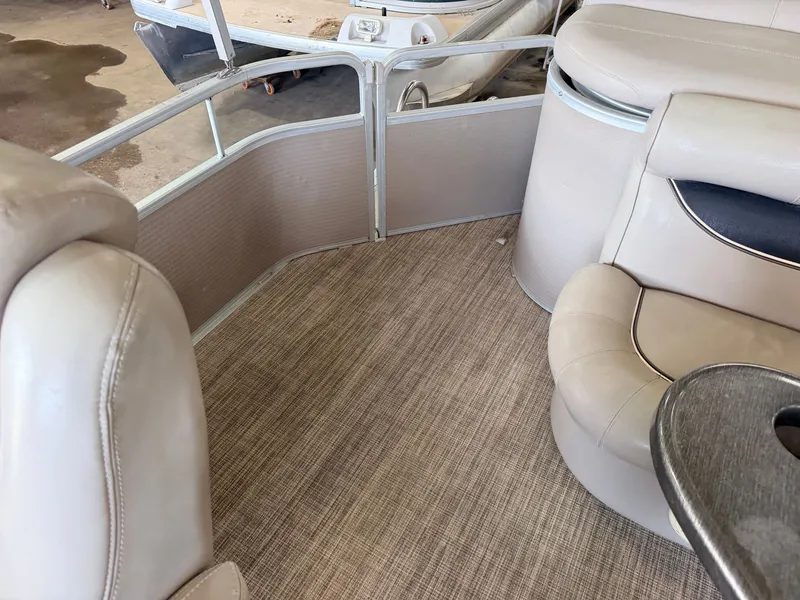 Slide: The Image of Interior of a 2007 Premier 210 Legend with beige seating and carpeted floor. - 33