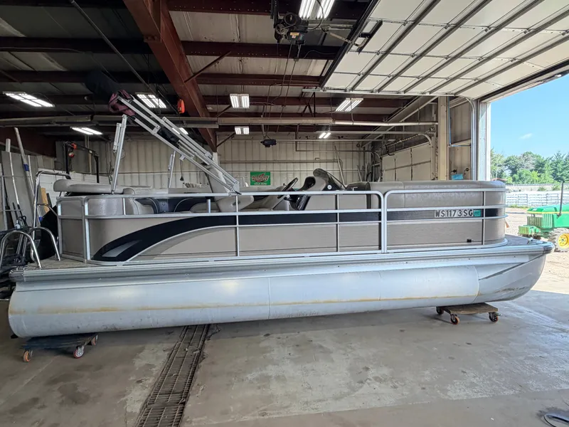 Slide: The Image of A 2007 Premier 210 Legend pontoon boat in a storage facility. - 44