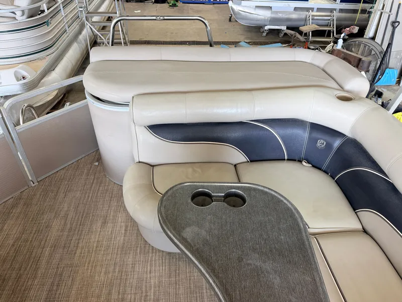 Slide: The Image of Interior of a 2007 Premier 210 Legend with beige and blue upholstered seating. - 32