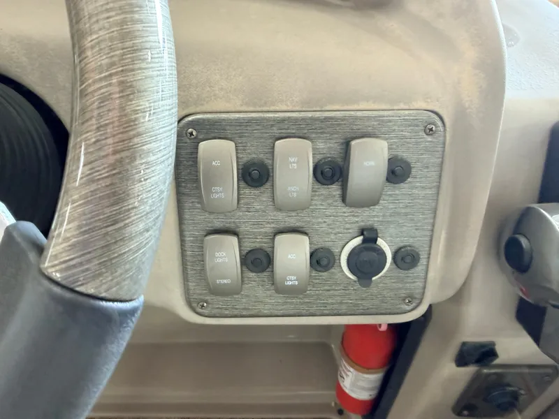 Slide: The Image of Close-up of a control panel with switches and a fire extinguisher below. - 24