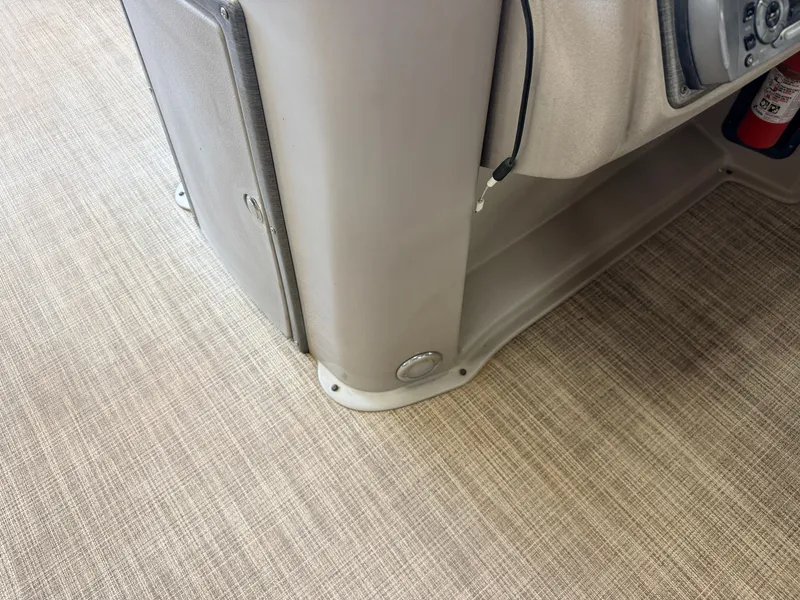 Slide: The Image of Close-up of a boat deck with beige carpet and a gray dashboard. - 19