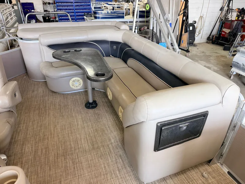 Slide: The Image of The image shows a luxurious seating area on a pontoon boat with a table and comfortable cushions. - 27
