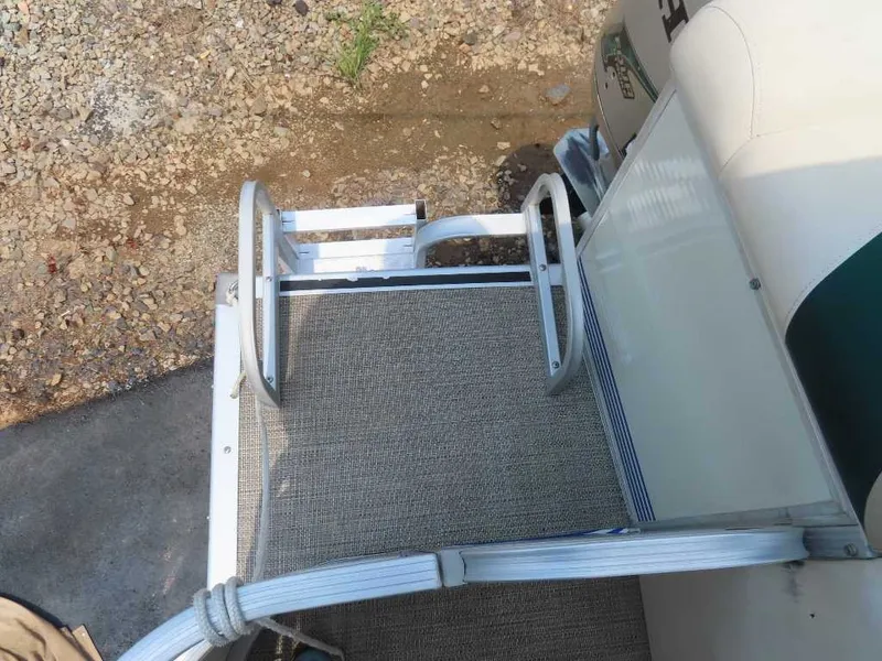 Slide: The Image of A 1999 Bennington Pontoon with a sturdy boarding ladder and carpeted deck area. - 20