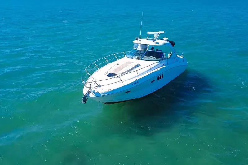 Slide: The Image of 2008 Sea Ray 380 Sundancer yacht cruising on clear blue ocean waters. - 80