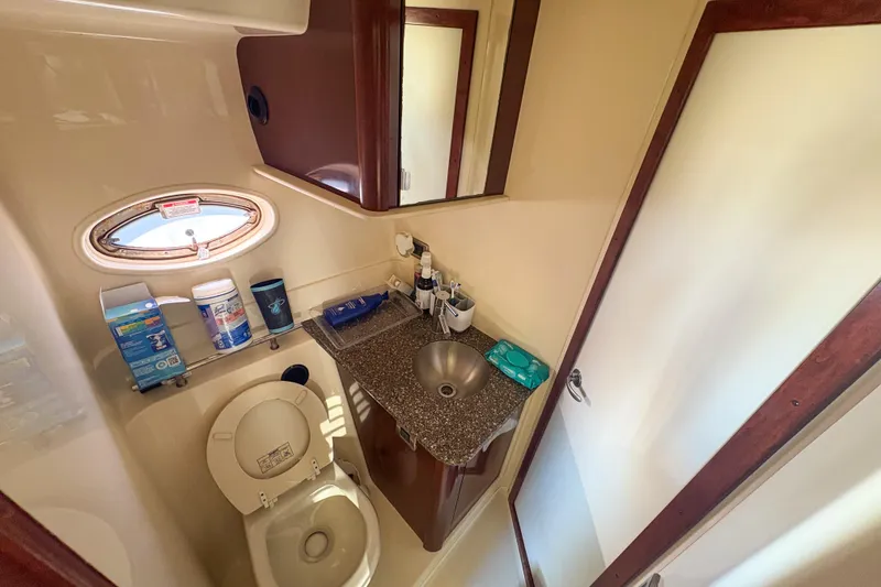 Slide: The Image of Compact bathroom in 2008 Sea Ray 380 Sundancer yacht with sink, toilet, and porthole window. - 55