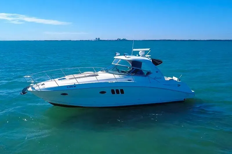 Slide: The Image of 2008 Sea Ray 380 Sundancer yacht cruising on clear blue waters. - 5