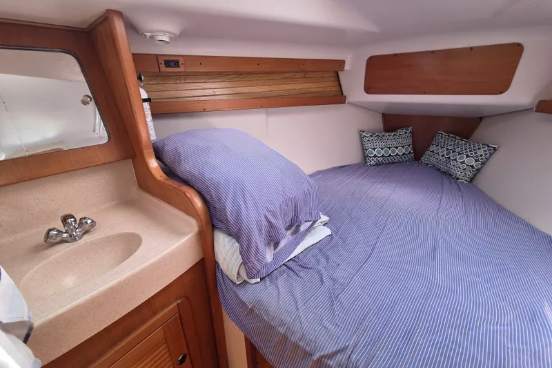 Slide: The Image of Cozy cabin interior of 2002 Catalina 390 sailboat with bed and sink. - 35