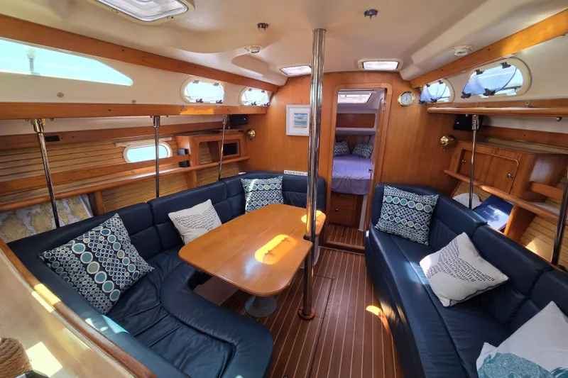Slide: The Image of Interior of 2002 Catalina 390 sailboat with cozy seating and wooden finishes. - 30