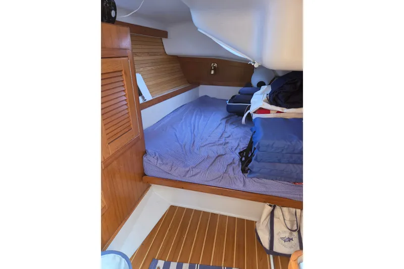 Slide: The Image of Cozy cabin interior of 2002 Catalina 390 sailboat with wooden accents and bedding. - 37