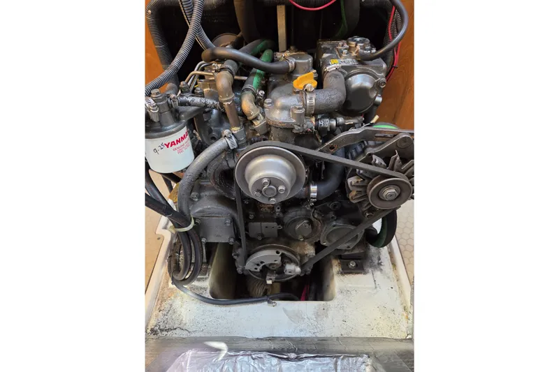 Slide: The Image of Engine of a 2002 Catalina 390 sailboat, featuring Yanmar components and visible belts. - 42