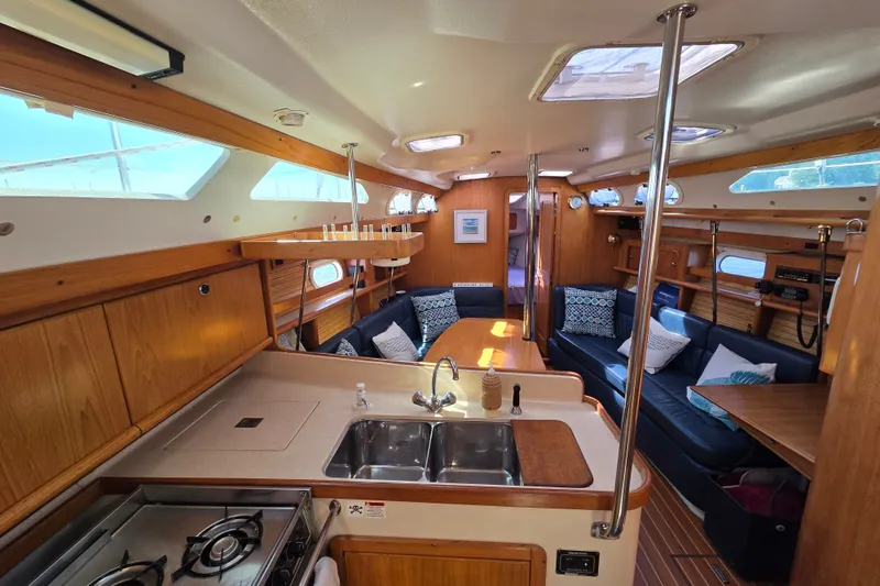 Slide: The Image of Interior of a 2002 Catalina 390 sailboat with cozy seating and modern kitchen amenities. - 29