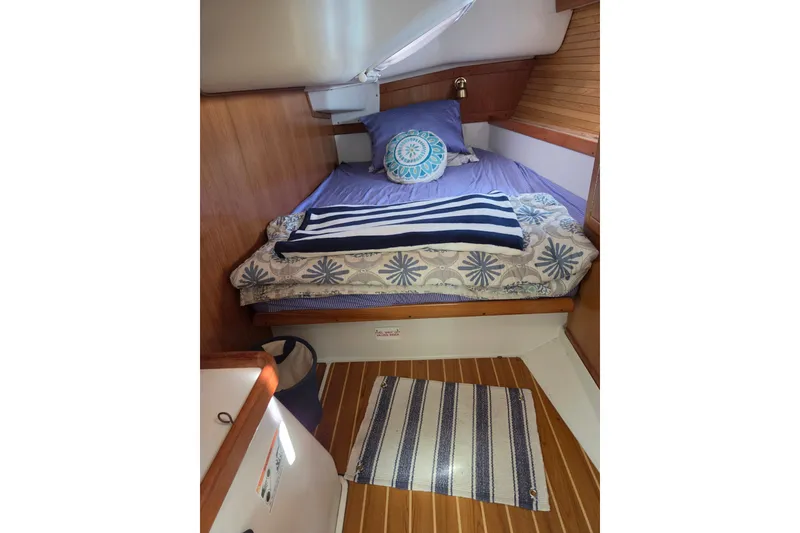 Slide: The Image of Cozy cabin interior of 2002 Catalina 390 sailboat with bed and nautical decor. - 36