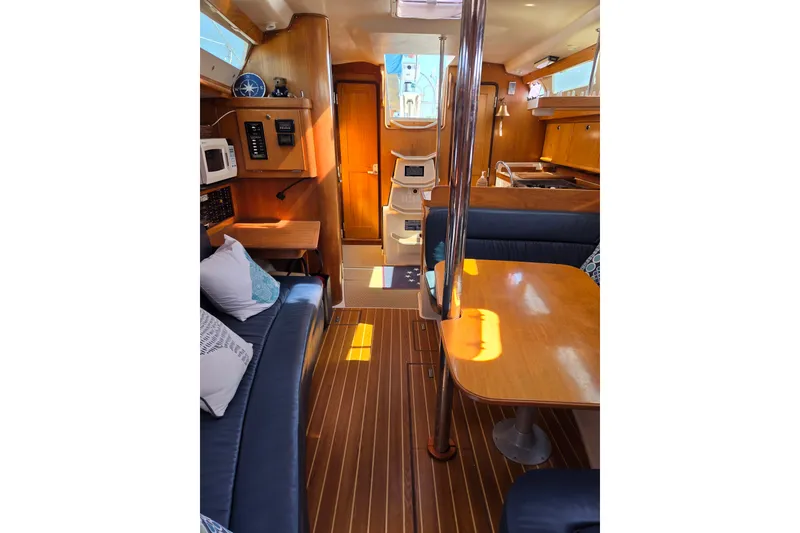 Slide: The Image of Interior of 2002 Catalina 390 sailboat with wood finish and cozy seating area. - 33