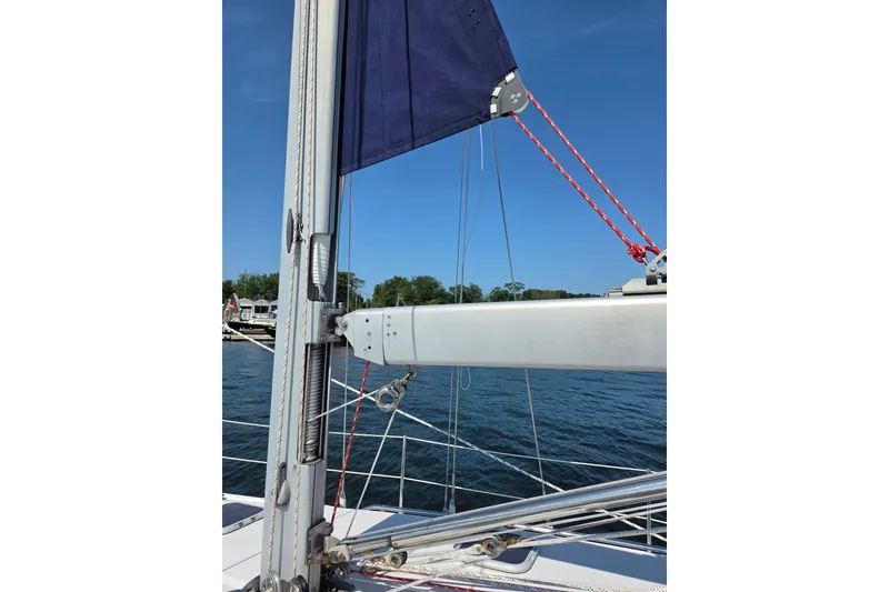 Slide: The Image of Sailboat mast and rigging on a 2002 Catalina 390, with blue sky and water backdrop. - 28