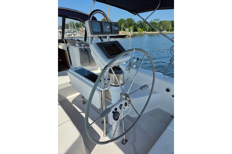 Slide: The Image of Cockpit of 2002 Catalina 390 sailboat with steering wheel and navigation instruments. - 13
