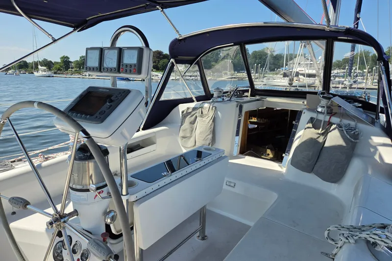 Slide: The Image of Cockpit of a 2002 Catalina 390 sailboat with navigation instruments and marina view. - 15
