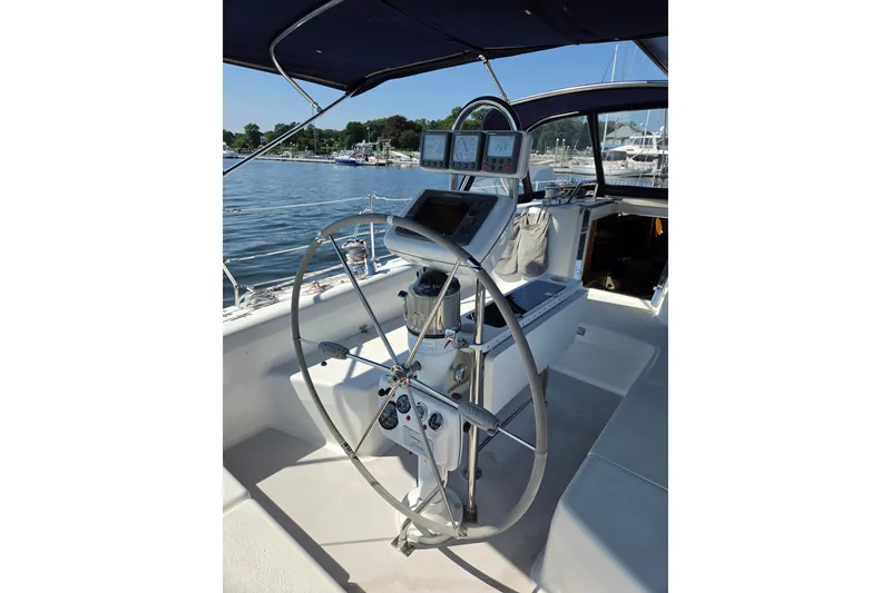 Slide: The Image of Cockpit of a 2002 Catalina 390 sailboat with steering wheel and navigation instruments. - 16