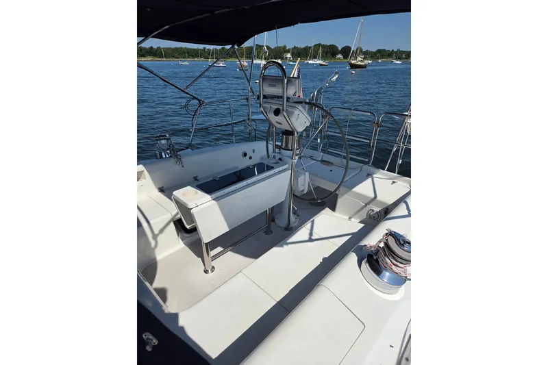 Slide: The Image of Cockpit of 2002 Catalina 390 sailboat with steering wheel, docked on calm water. - 18