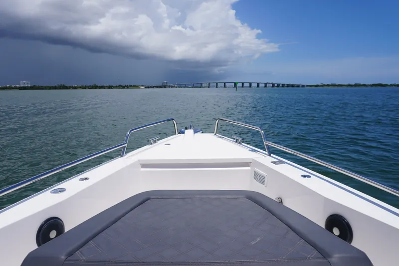 Slide: The Image of Bow view of 2020 Axopar 37 XC Cross Cabin on open water under cloudy sky. - 16