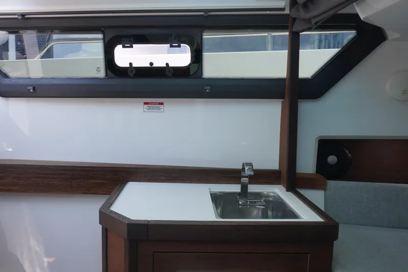 Slide: The Image of 2020 Axopar 37 XC Cross Cabin interior with sink and window view. - 26