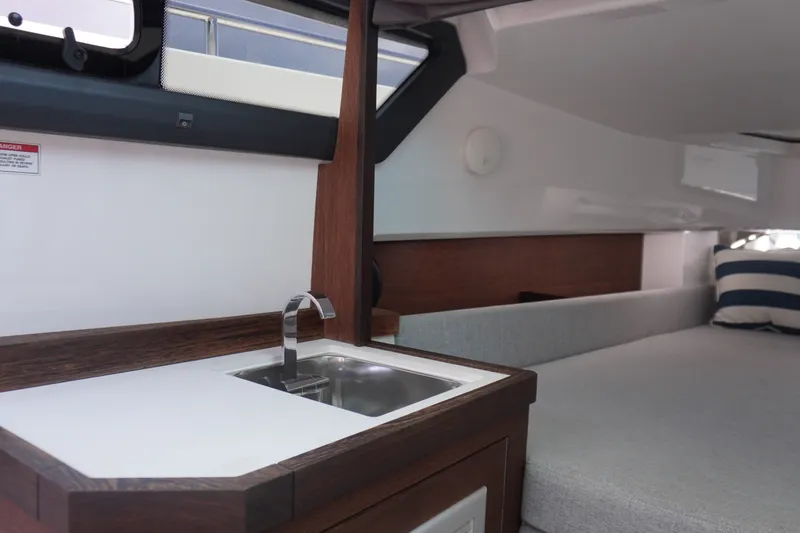 Slide: The Image of Interior of 2020 Axopar 37 XC Cross Cabin with sink and seating area. - 22