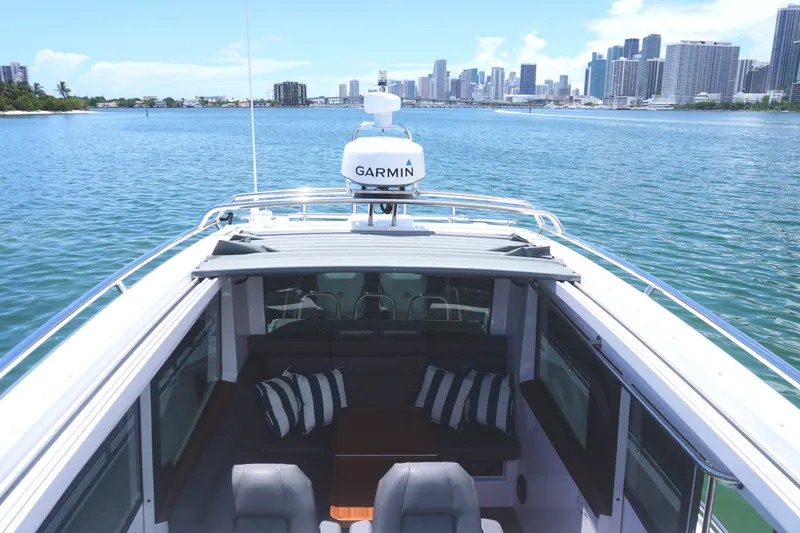 Slide: The Image of 2020 Axopar 37 XC Cross Cabin boat with city skyline in background. - 13