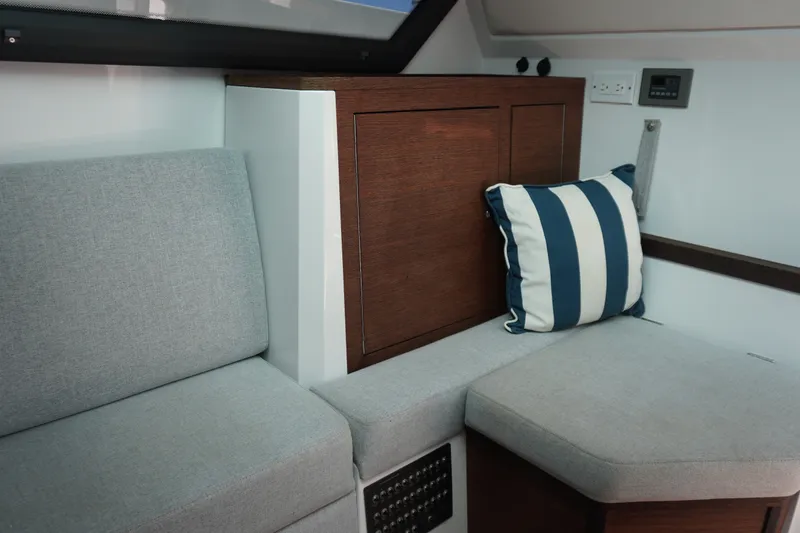 Slide: The Image of Interior of 2020 Axopar 37 XC Cross Cabin with gray seating and striped cushion. - 25
