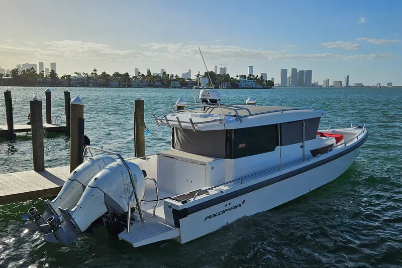 The Image of 2020 Axopar 37 XC Cross Cabin boat docked with city skyline in background. - 0