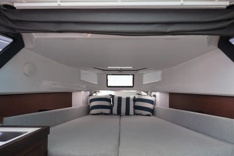 Slide: The Image of Interior cabin of 2020 Axopar 37 XC Cross Cabin with striped cushions. - 23