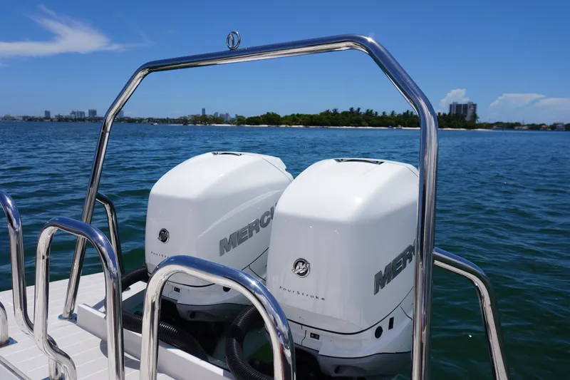 Slide: The Image of Twin Mercury outboard engines on a 2020 Axopar 37 XC Cross Cabin boat, ocean backdrop. - 21