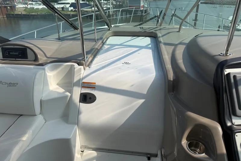 Slide: The Image of 2008 Cruisers Yachts 520 Express cockpit with seating and control panel, docked at marina. - 29