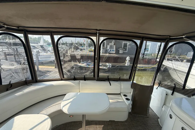 Slide: The Image of Interior of 2008 Cruisers Yachts 520 Express with seating and table, docked at marina. - 25