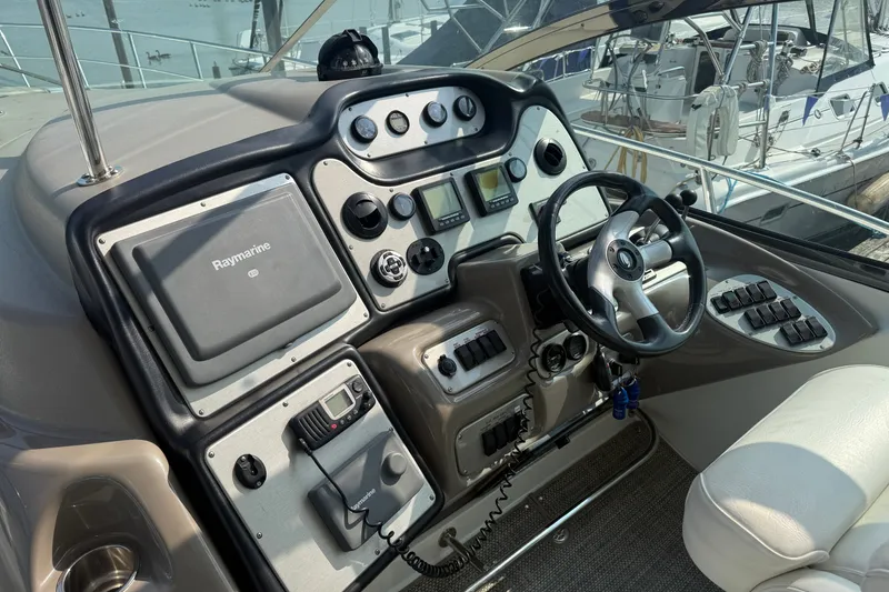 Slide: The Image of Cockpit of 2008 Cruisers Yachts 520 Express with steering wheel and navigation controls. - 30