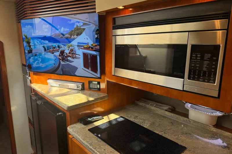 Slide: The Image of Luxurious 2008 Cruisers Yachts 520 Express interior with modern kitchen appliances and elegant design. - 17