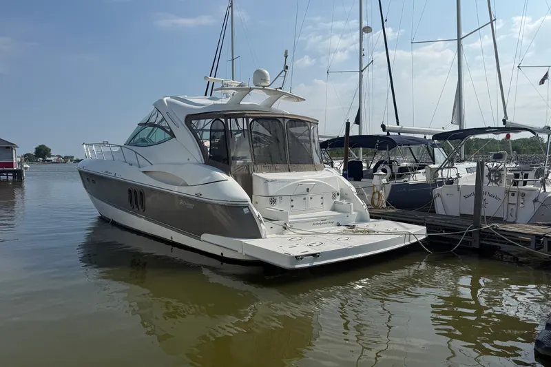 The Image of 2008 Cruisers Yachts 520 Express docked at marina, rear view. - 0