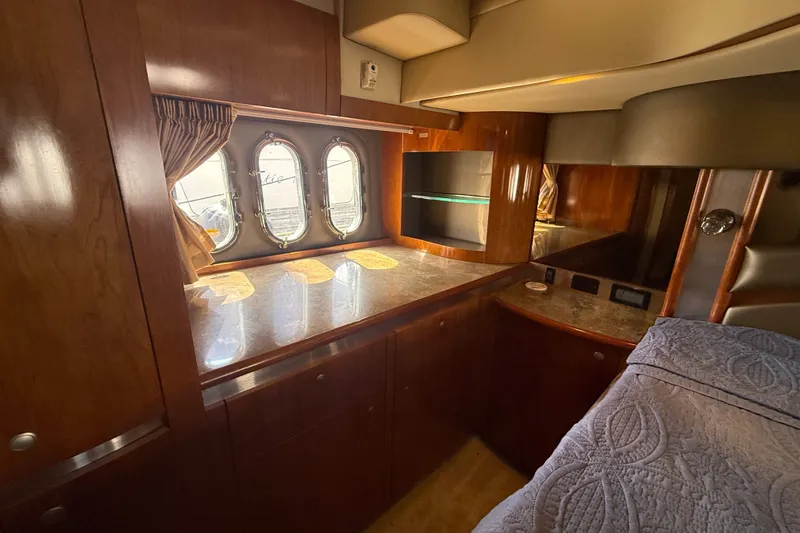 Slide: The Image of Luxurious 2008 Cruisers Yachts 520 Express cabin interior with elegant wood finish and porthole windows. - 15