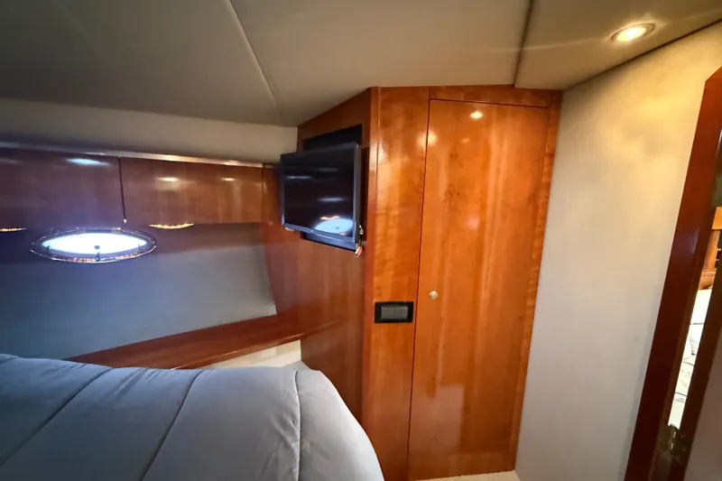 Slide: The Image of Luxurious cabin interior of 2008 Cruisers Yachts 520 Express with wood paneling and TV. - 20
