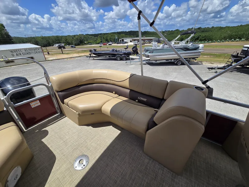 Slide: The Image of A 2020 Lowe SF 232 pontoon boat with beige seating and an open deck. - 23